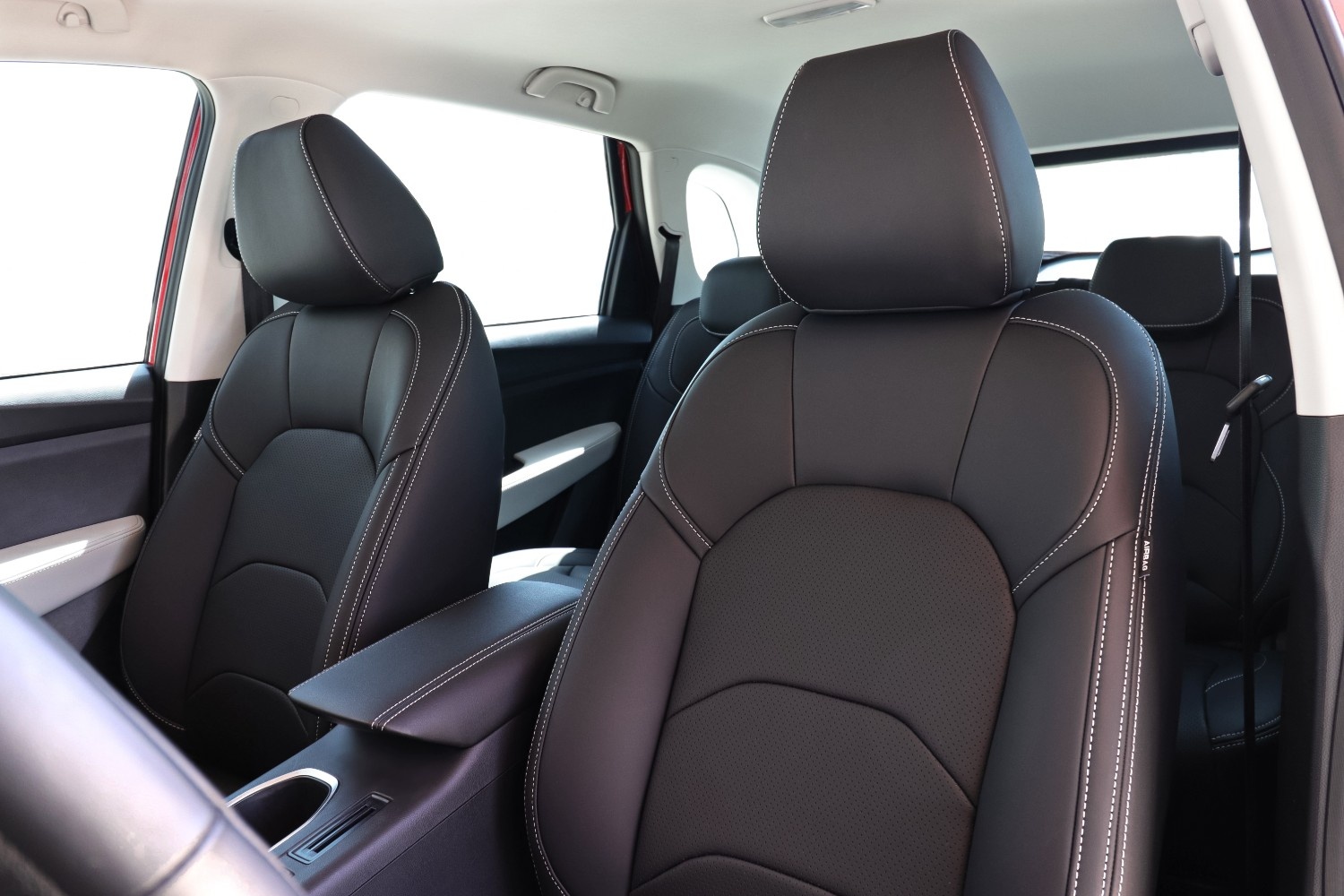 Complete car seat re-upholstery in progress showing genuine leather being fitted to front seats with professional stitching and padding restoration