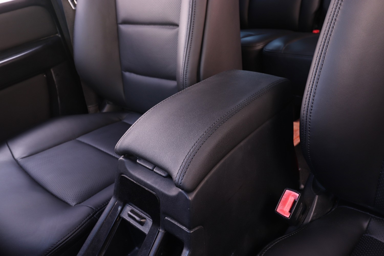 Premium vehicle interior upholstery makeover showing freshly installed leather seats, door panel upholstery, and dashboard trim in a luxury SUV